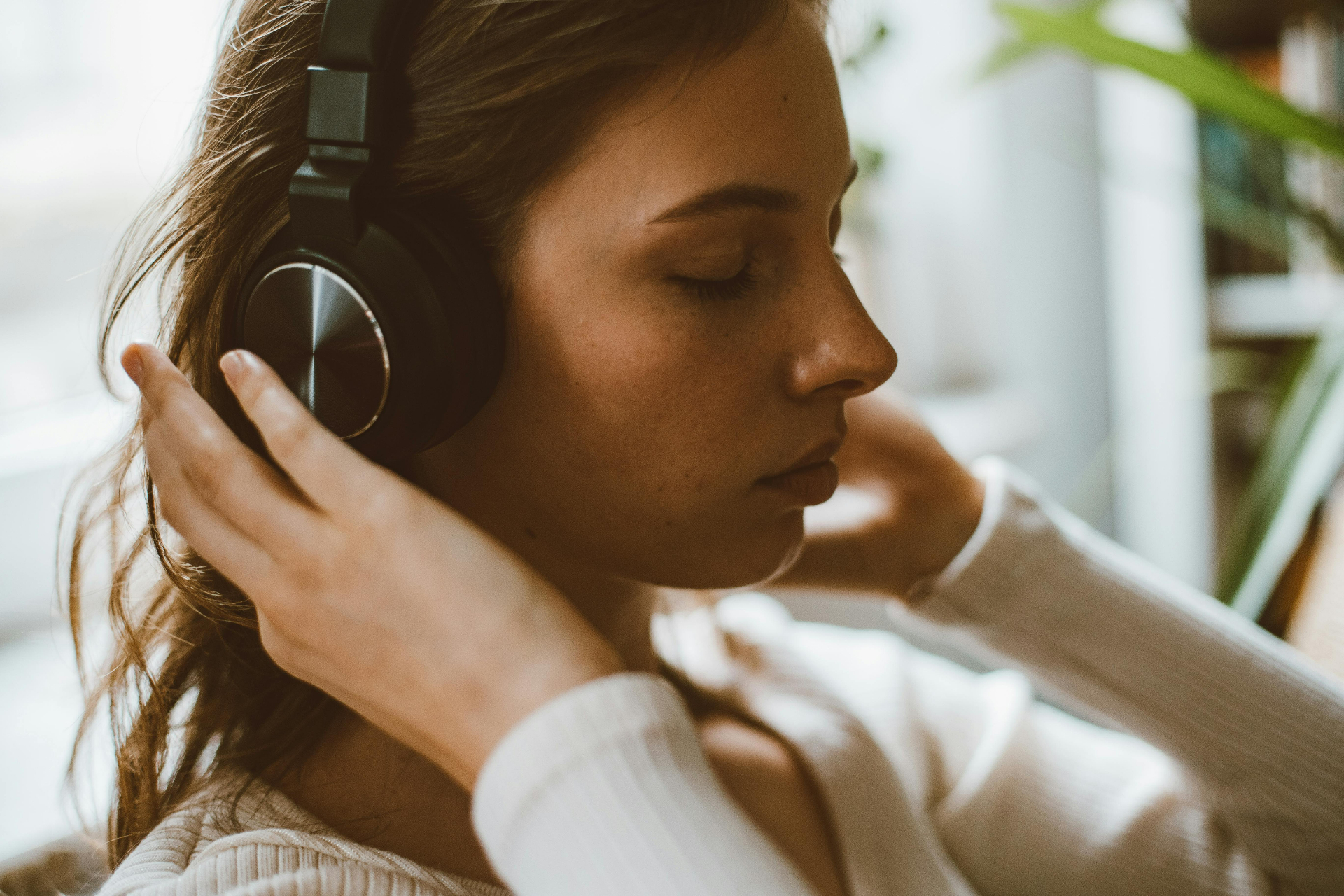Person listening to Safe and Sound Protocol music during a nervous system regulation session at New Moon Psychotherapy in Toronto